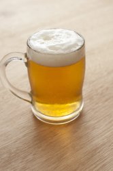 Tankard of beer with a frothy head