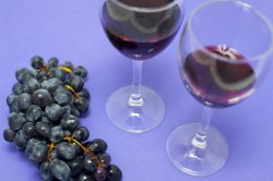 Two glasses of red wine with grapes
