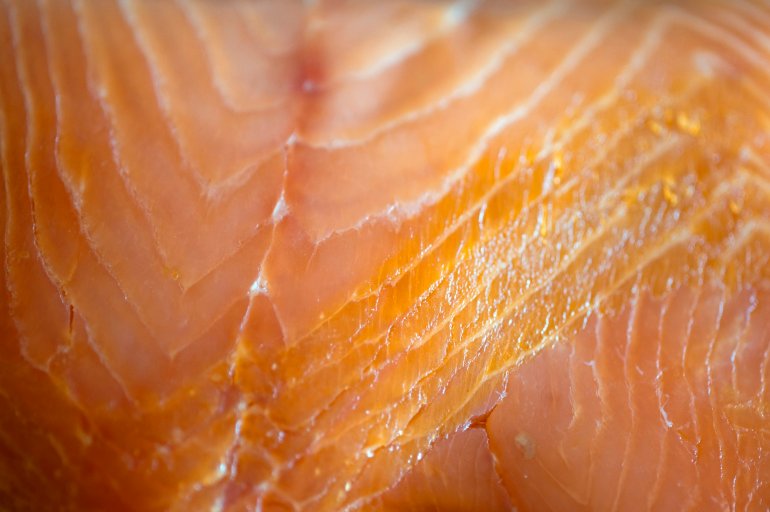 Background texture of a raw salmon fillet, a healthy seafood ingredient rich in omega-3