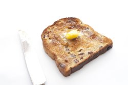 Slice of hot fruity toast with butter