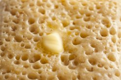 close up crumpet with butter