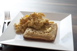 Single toasted crumpet and scrambled eggs