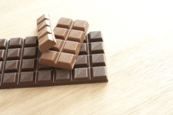 Sections of milk and dark chocolate on table