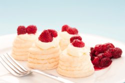Meringues and cream with raspberries