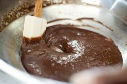 Cook making a bowl of chocolate icing