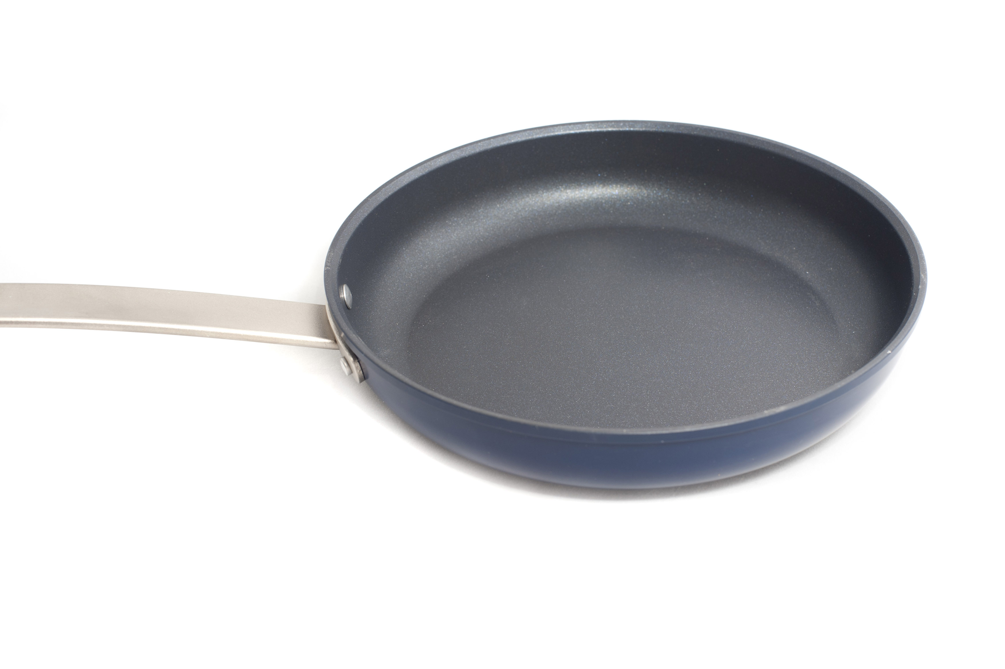 Clean nonstick frying pan isolated on white Free Stock Image
