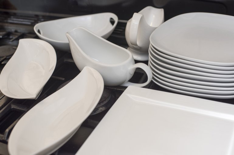 Generic white dinnerware set Generic white dinnerware set with assorted plates, jugs and gravy boats ready to serve food