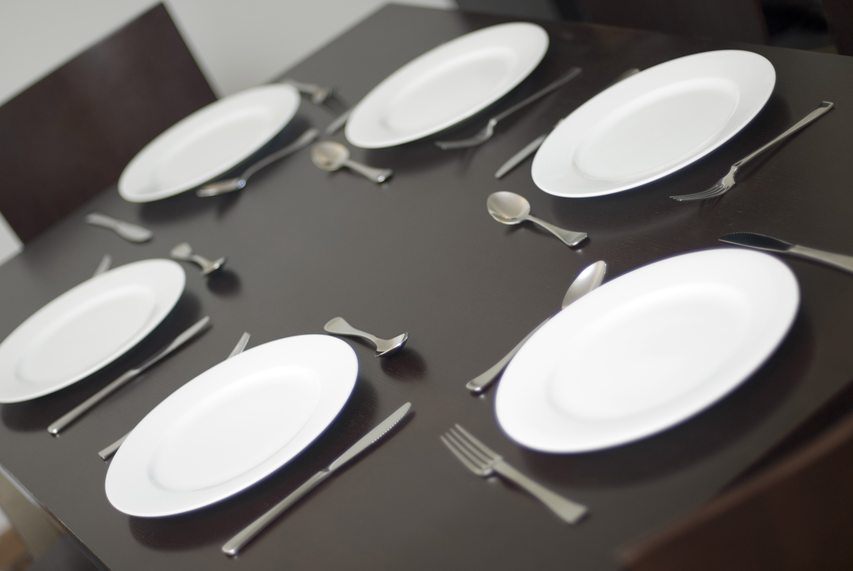 Place setting and plates on a table with no food - Free Stock Image