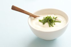 Bowl of sour cream garnished with chives