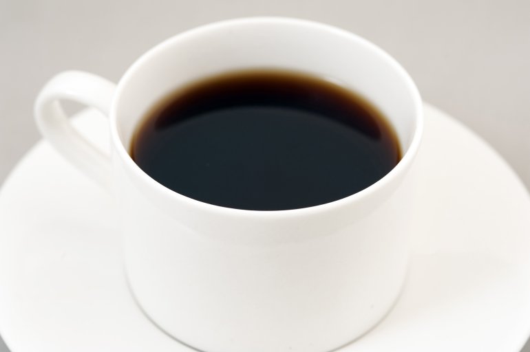 Black energizing coffee served in a white cup - Free Stock Image