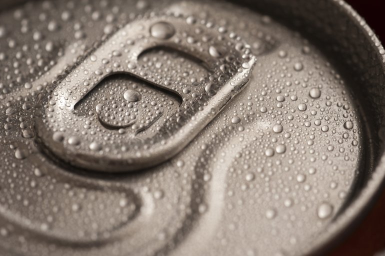 Ice cold beverage in a can Ice cold beverage in a can with a closeup view of the unopened pull tab on the lid with condensed water droplets