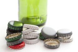 Empty green bottle with assorted tops