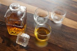 Open whiskey decanter with glasses