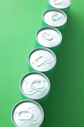 Cans of energy drink on green