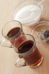 Two cups of hot sweet black tea