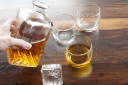 Man pouring whiskey from a decanter