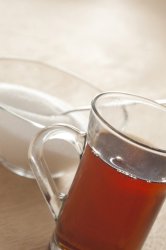 Glass cup of black tea with sugar