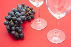 Grapes and Wine Glasses on Red Background