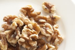 Pile of walnuts on white plate