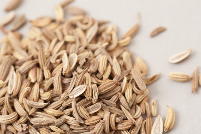 Close up of whole caraway seeds piled on bench A close up of whole caraway seeds piled on a bench with a shallow depth of field.