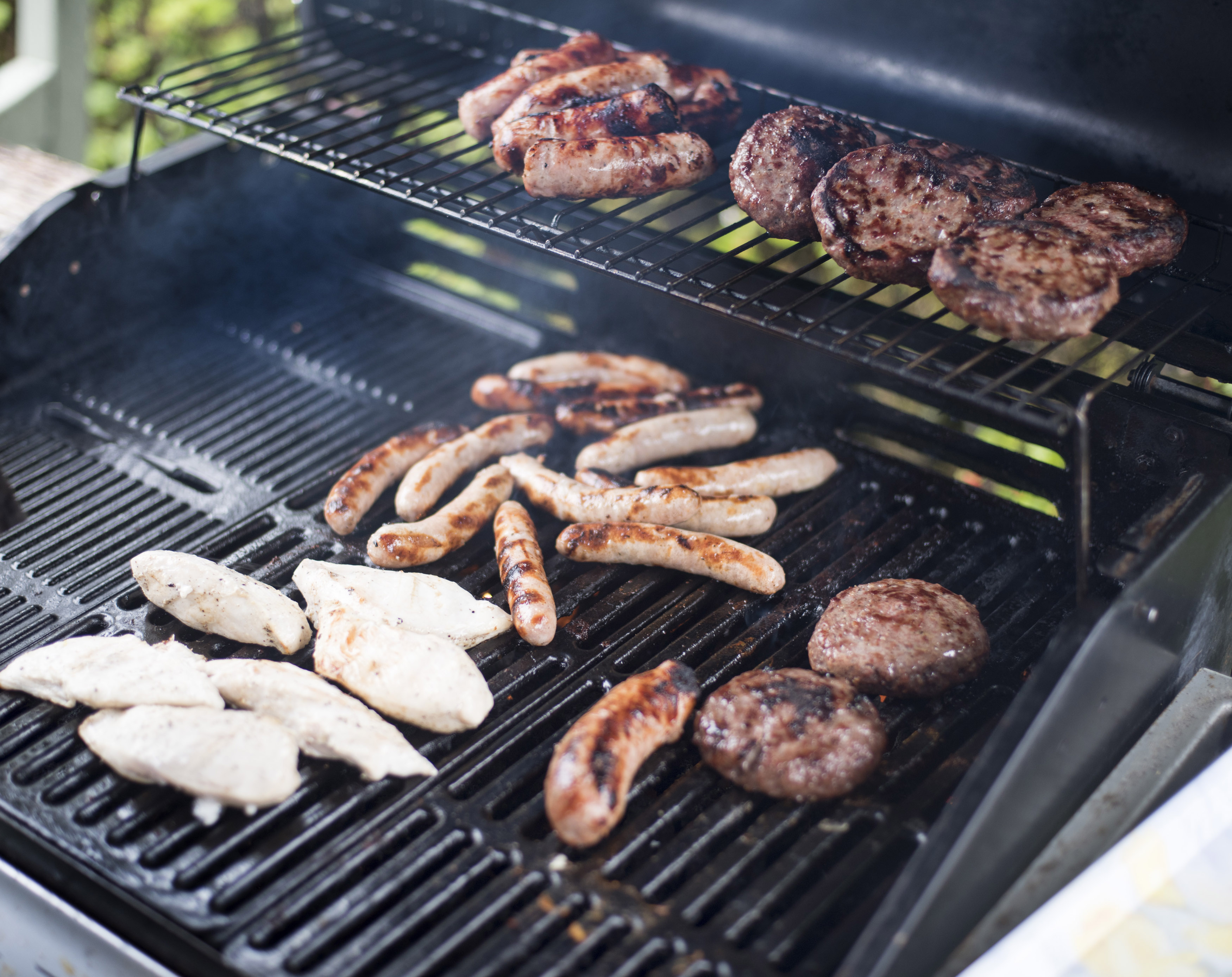 Assorted meat grilling over a BBQ fire Free Stock Image