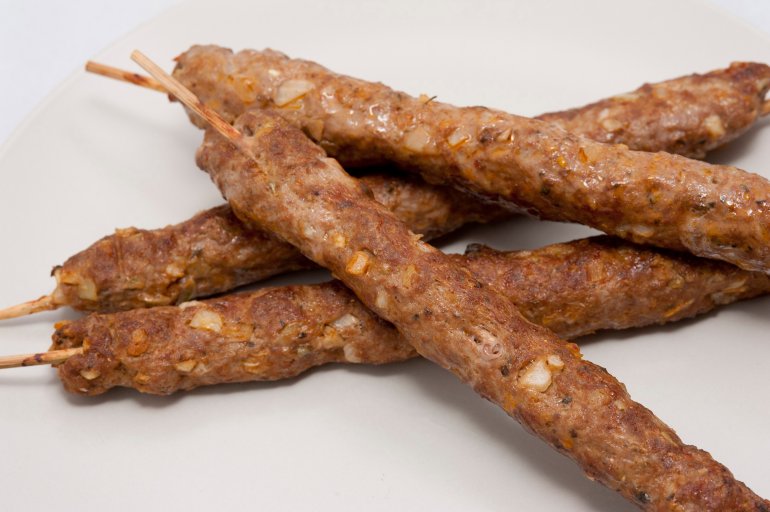 Four delisious grilled kofta lamb kebabs made from spicy minced lamb and cooked on a skewer for a traditional snack