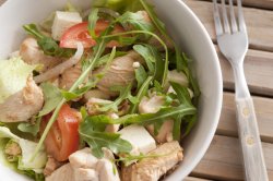Healthy salad with chicken pieces and rocket