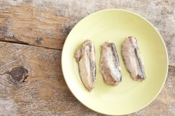 Three sardines in middle of round plate