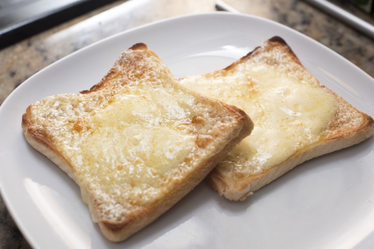 Toasted bread with melted cheese Free Stock Image