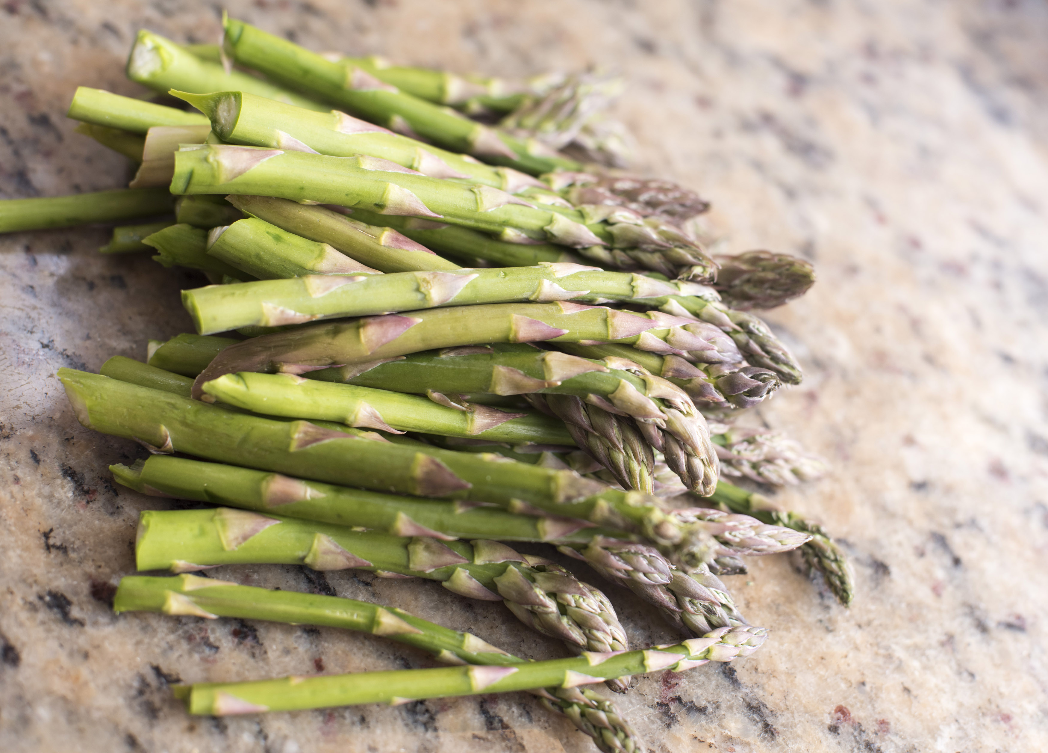 A bunch of fresh asparagus on the table Free Stock Image