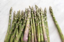 Pile of fresh green asparagus tips or spears