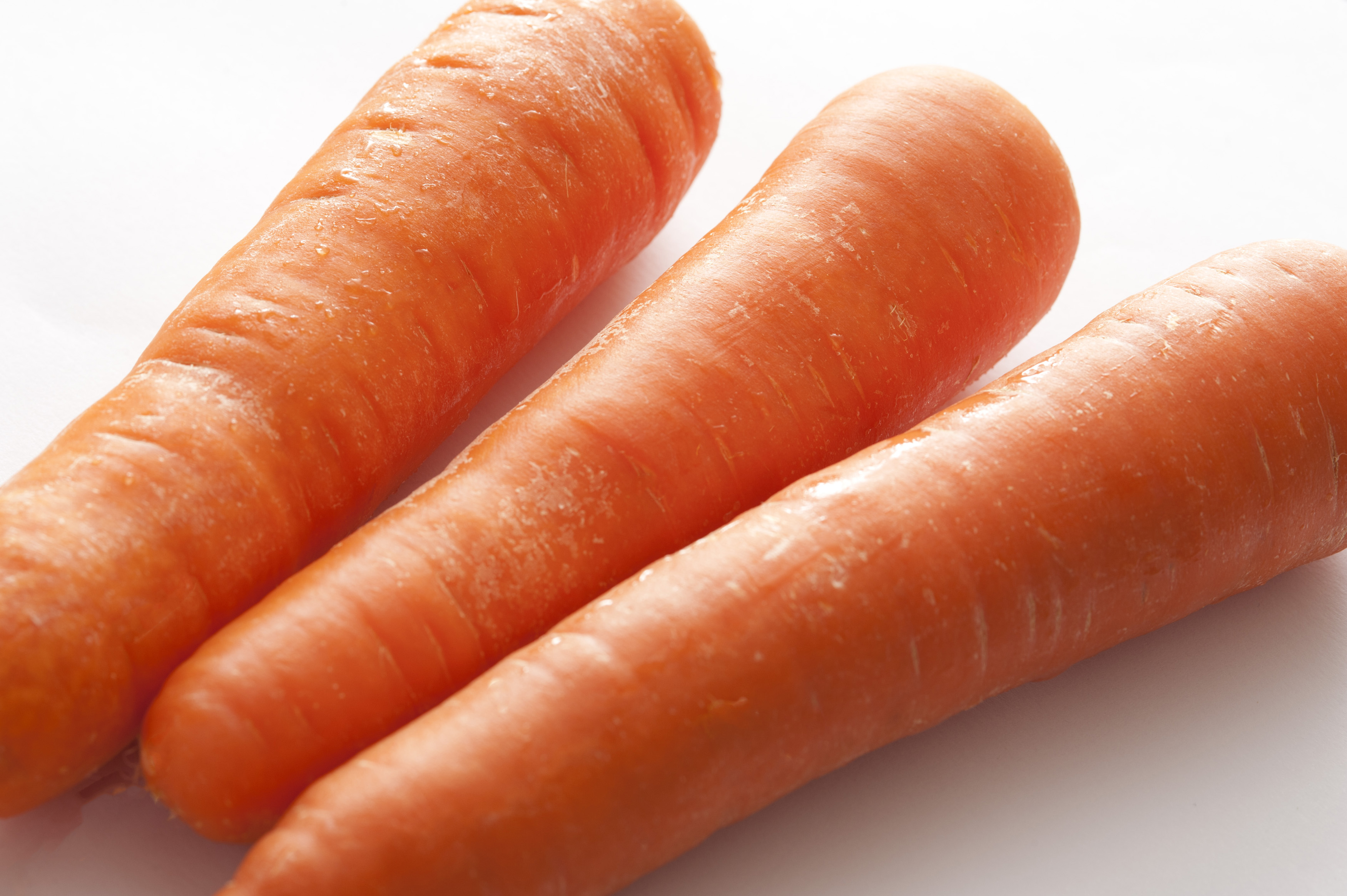 Trio of fresh raw carrots Free Stock Image